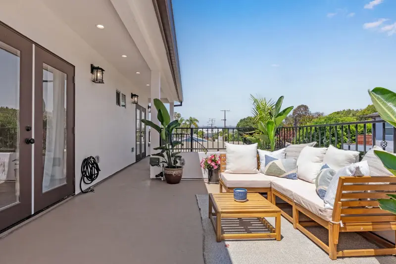 West LA ADU rooftop deck with outdoor sectional sofa, lounge furniture, planters, and Mediterranean tile detail