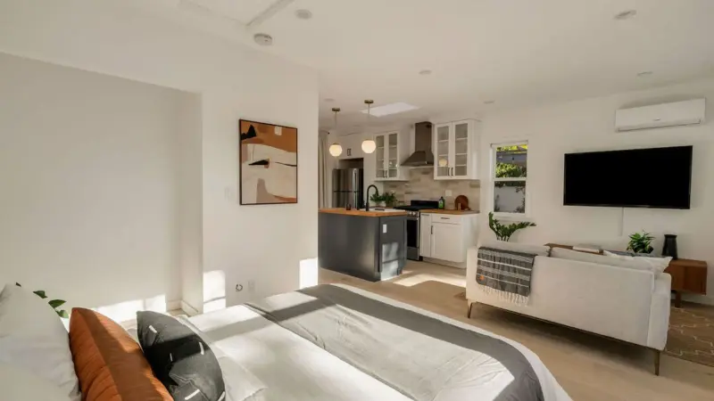 Studio layout of Burbank garage conversion ADU — bed, living area, and full kitchen in one open, light-filled space