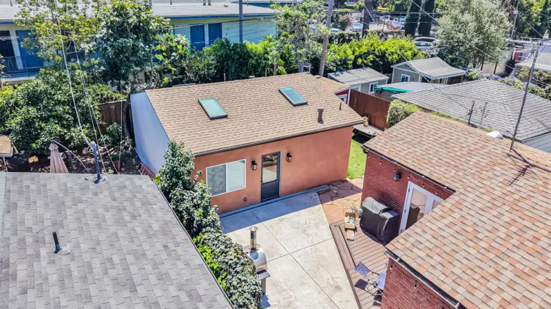 Aerial view of the Mar Vista garage conversion ADU showing the new vaulted roof with three skylights and the patio between the ADU and main house