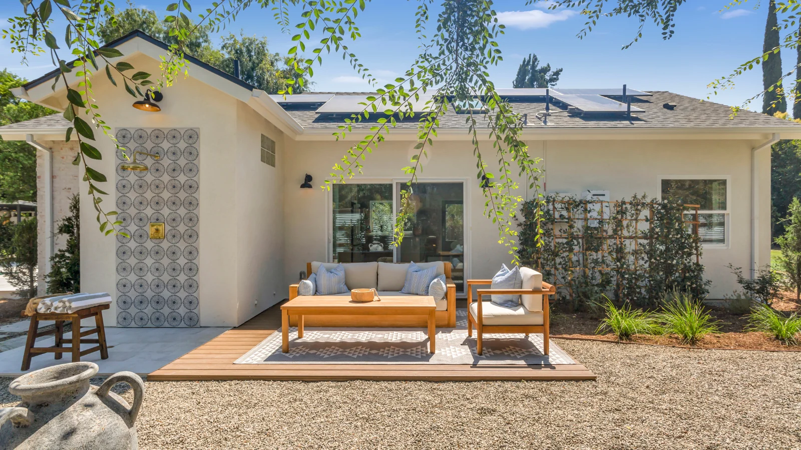 Woodland Hills pool house ADU — exterior detail showing the outdoor shower routed off the ADU's plumbing for poolside rinse-offs