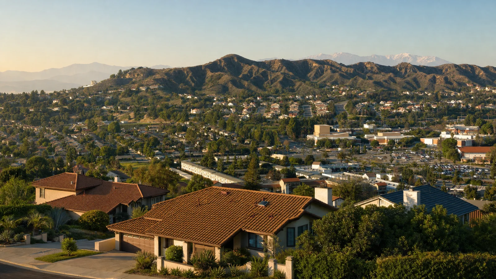 Building an ADU in Walnut, CA — tile-roof homes on a hillside street above the Walnut valley, the Mt. San Antonio College campus and the San Jose Hills, where CALI ADU designs and permits backyard ADUs under WMC § 6.08.210