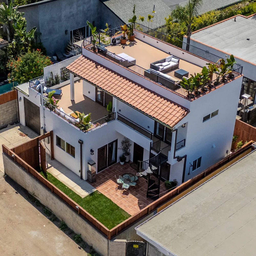 Custom CALI ADU in West LA — Mediterranean 1,200 sqft two-story design with 600 sqft wraparound rooftop deck, attached garage, and clay-tile roof